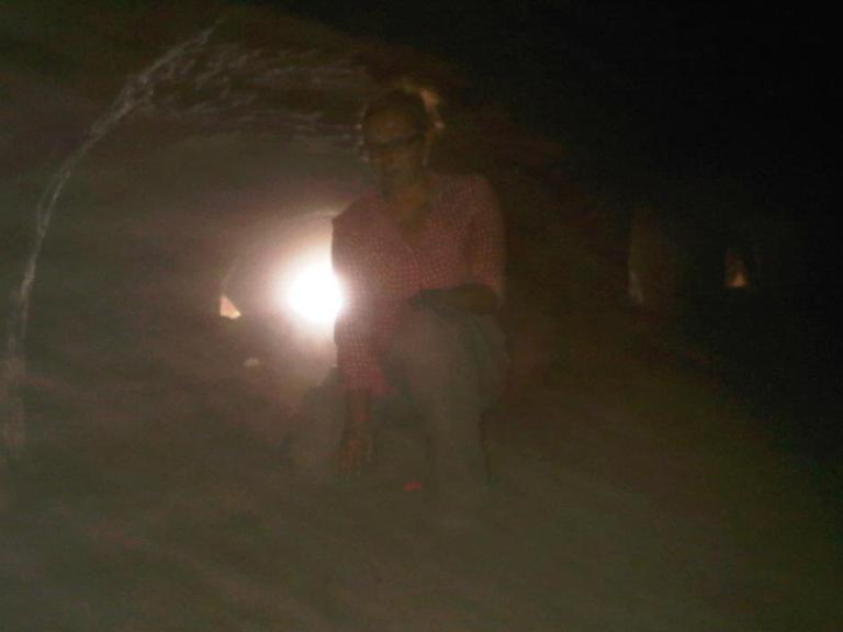 Ashley M. Richter crouched just inside the entrance to Umm al-Amad. The first section of the mine is particularly low-roofed and entrance involved crawling (again- remember the goat dung). The deeper into the system one goes, the taller the space. However, by the time of our survey- the majority of the deepest parts of the mine were already collapsed (a product of natural erosion over time and the recent nearby explosions). 