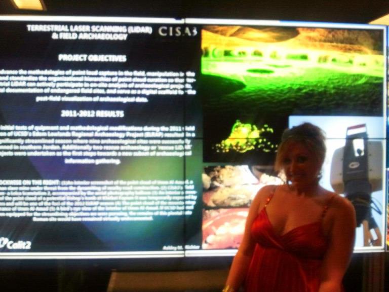 Ashley M. Richter in front of an Optiportable display of her recent work at the SME Building opening. 